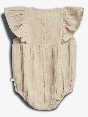 A beige baby romper with buttons and ruffled sleeves is displayed flat against a white background, featuring a textured fabric with small floral patterns.