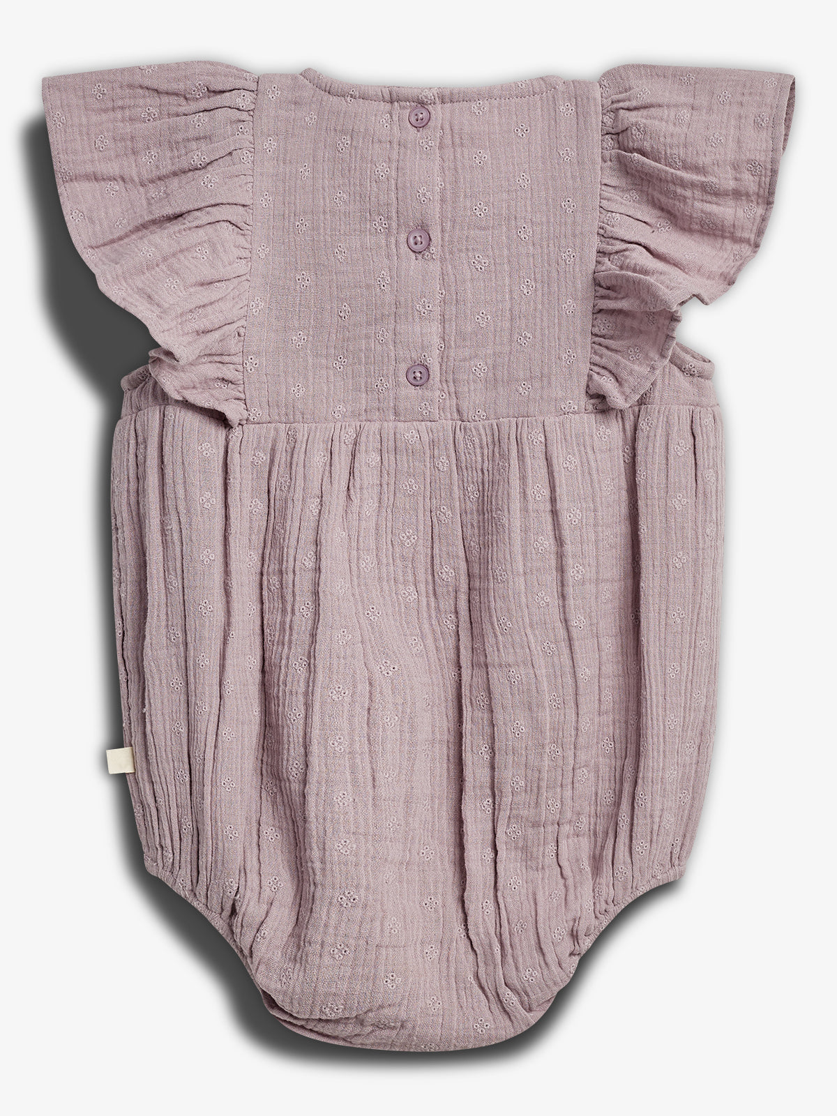 A lavender baby romper with ruffled cap sleeves and three buttons down the back; textured fabric features small floral patterns. It is displayed against a plain white background.