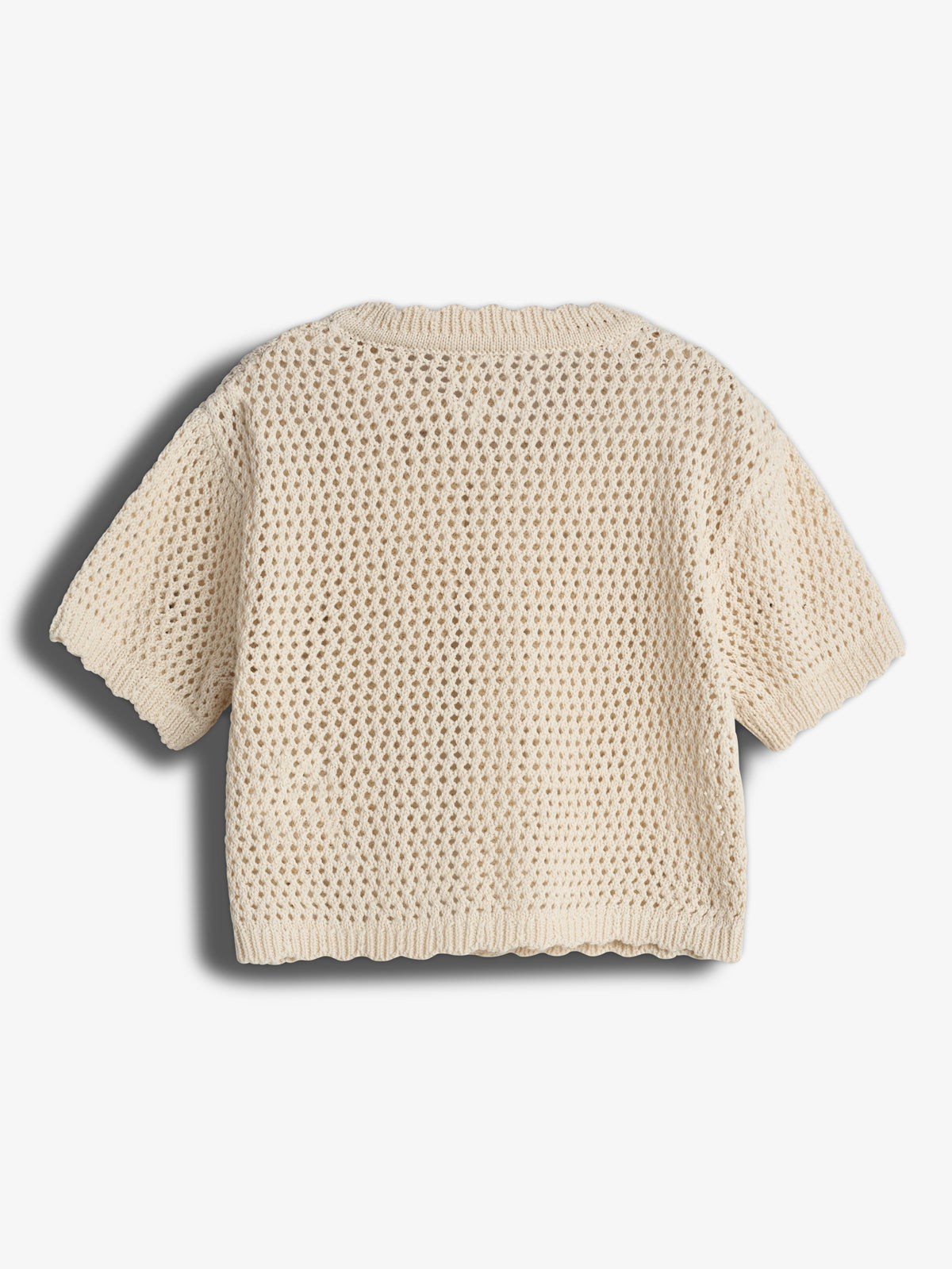 A cream-colored, short-sleeve, open-knit sweater displayed flat against a plain white background. The sweater's design features a textured, breathable pattern with ribbed edges at the bottom and sleeves.