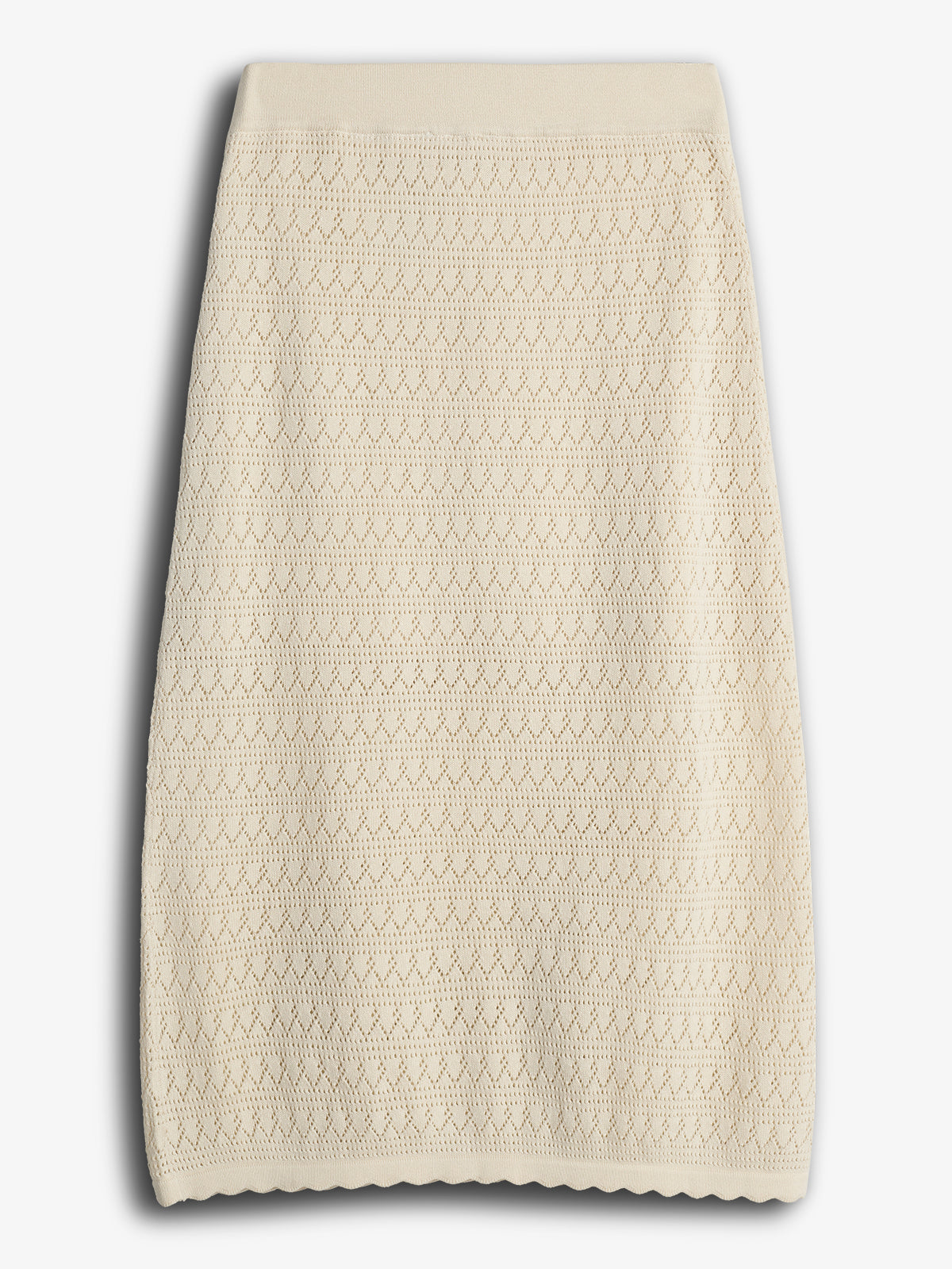 A cream knit skirt features a diamond pattern with textured stitching. It lies flat against a plain white background, showcasing its detailed design and straight hem.