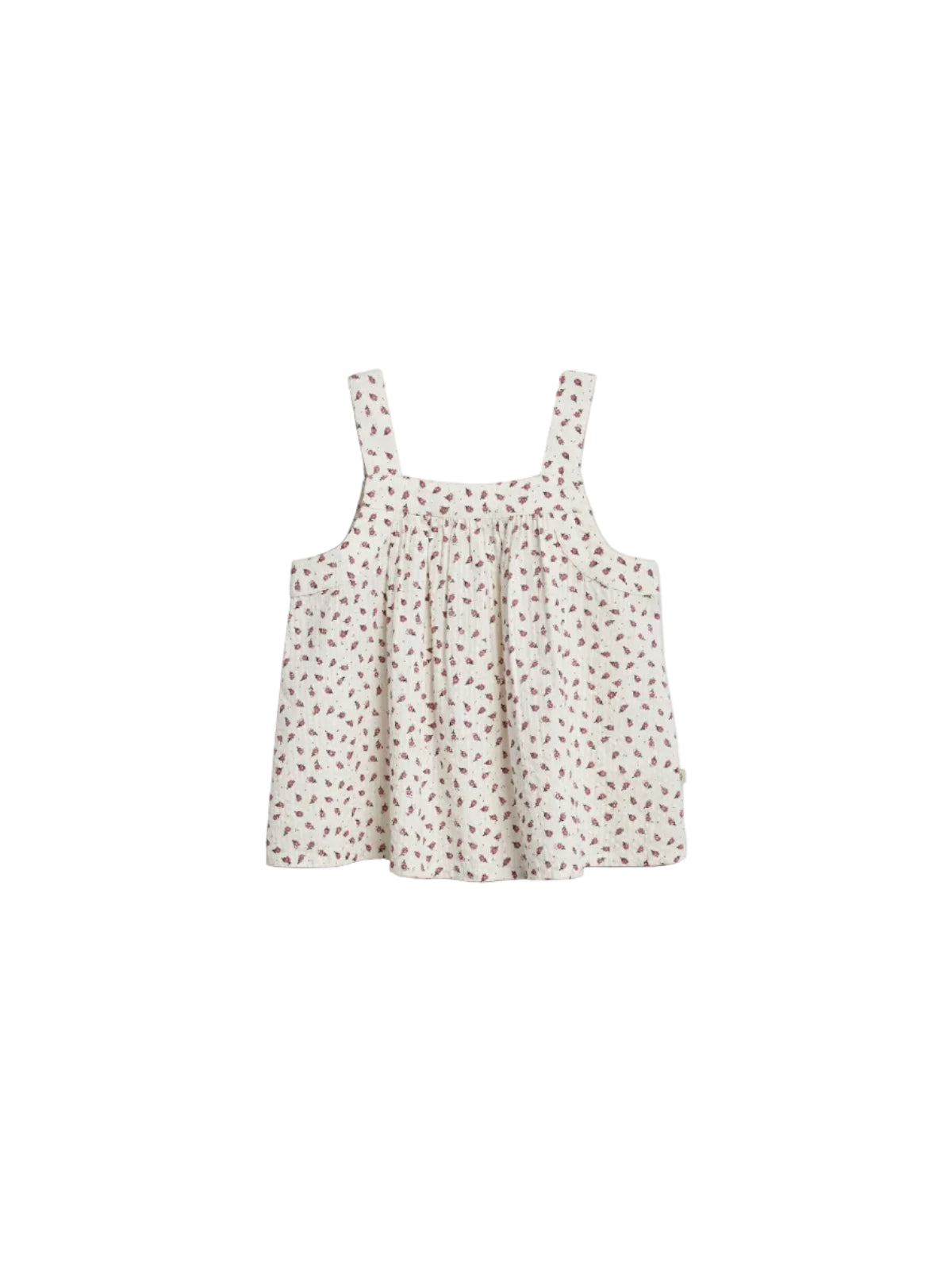 Sleeveless, floral-patterned dress with thick straps hangs against a plain backdrop. The fabric is light-colored with small, red floral designs scattered throughout.