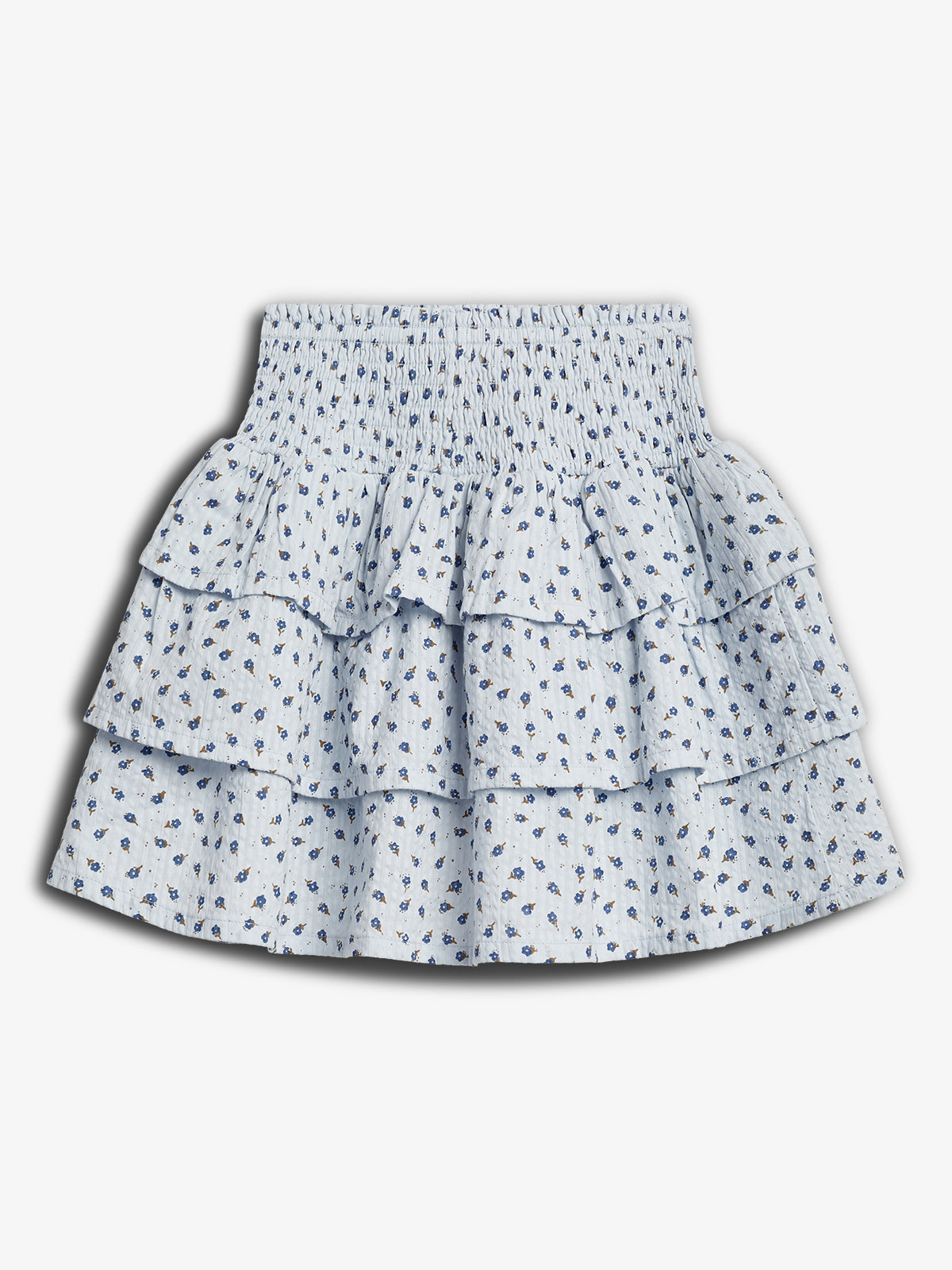 White skirt featuring blue floral patterns, displaying three tiers of ruffles, situated against a plain, white background.