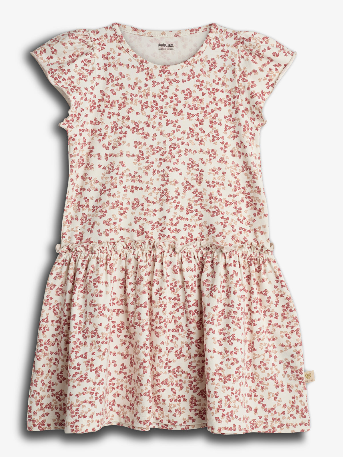 Kjolen har et hvidt stof med rødt blomsterprint, korte ærmer og en rynket nederdel. Den hænger mod en neutral baggrund. Mærket indeni siger: "POMPdeLUX, Made with care."