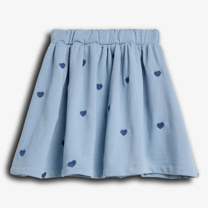 A light blue skirt with an elastic waistband, decorated with dark blue heart patterns, set against a plain white background.
