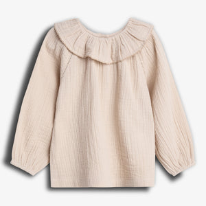 A cream-colored, long-sleeve blouse with a ruffled neckline is displayed from the back against a plain white background. The fabric appears textured and lightweight.