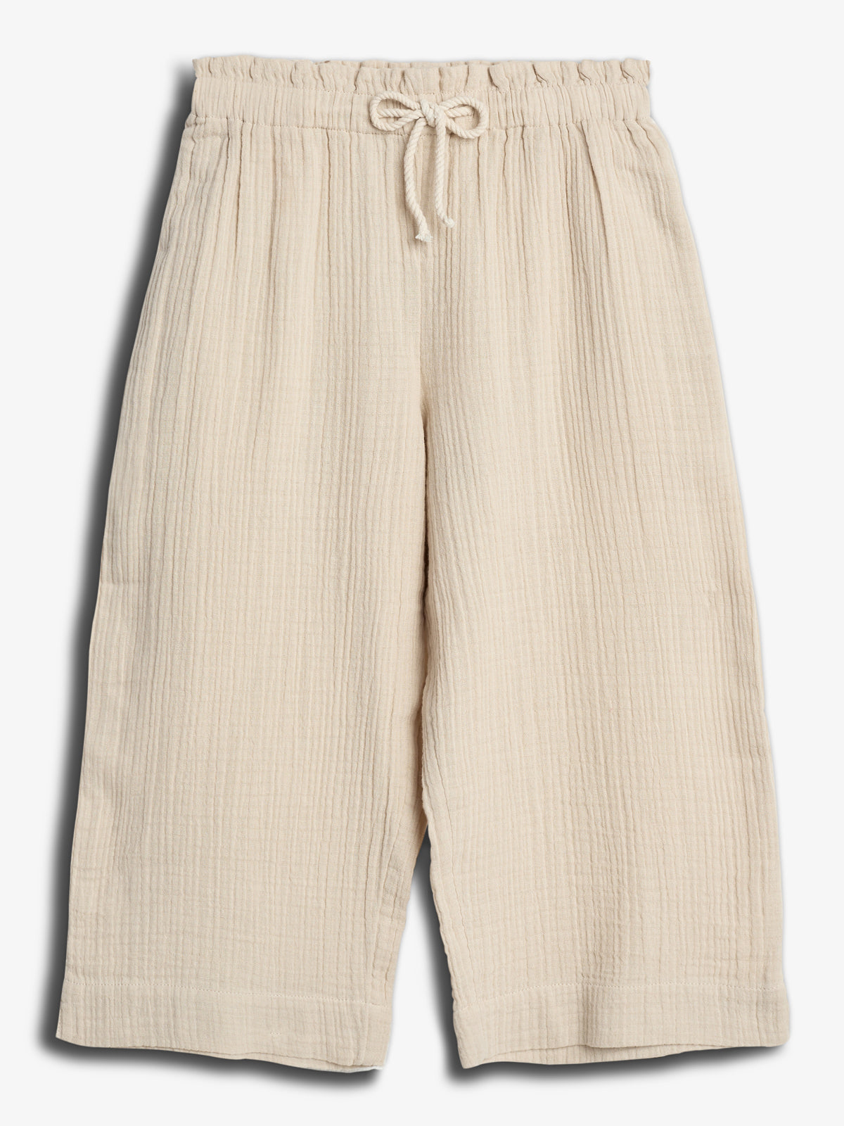 Cream-colored, wide-leg, textured pants with an elastic waistband and drawstring; the pants are laid flat on a neutral background.