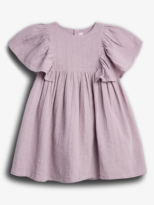 A lilac-colored, short-sleeved dress hangs against a plain white background, featuring a textured fabric with small embroidered patterns and a gathered, flowing skirt.