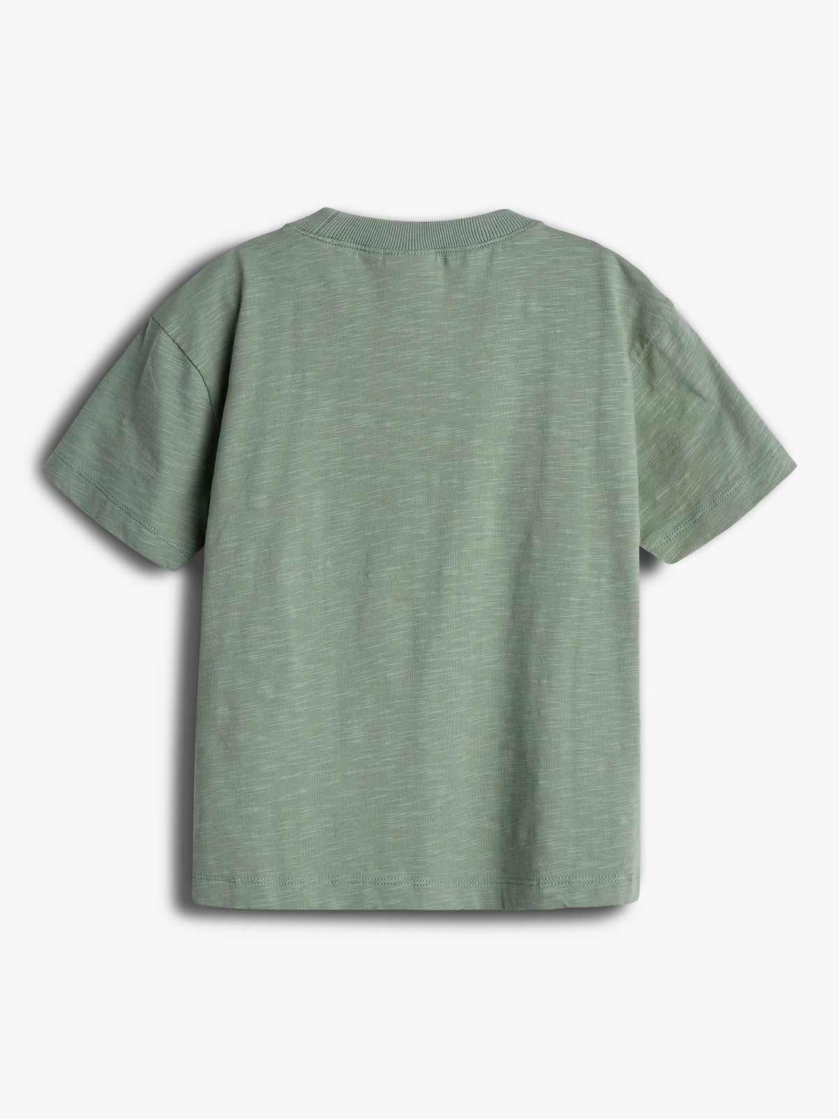 A green T-shirt is laid flat, showing its back side. The fabric appears smooth without any visible patterns or text, set against a plain white background.
