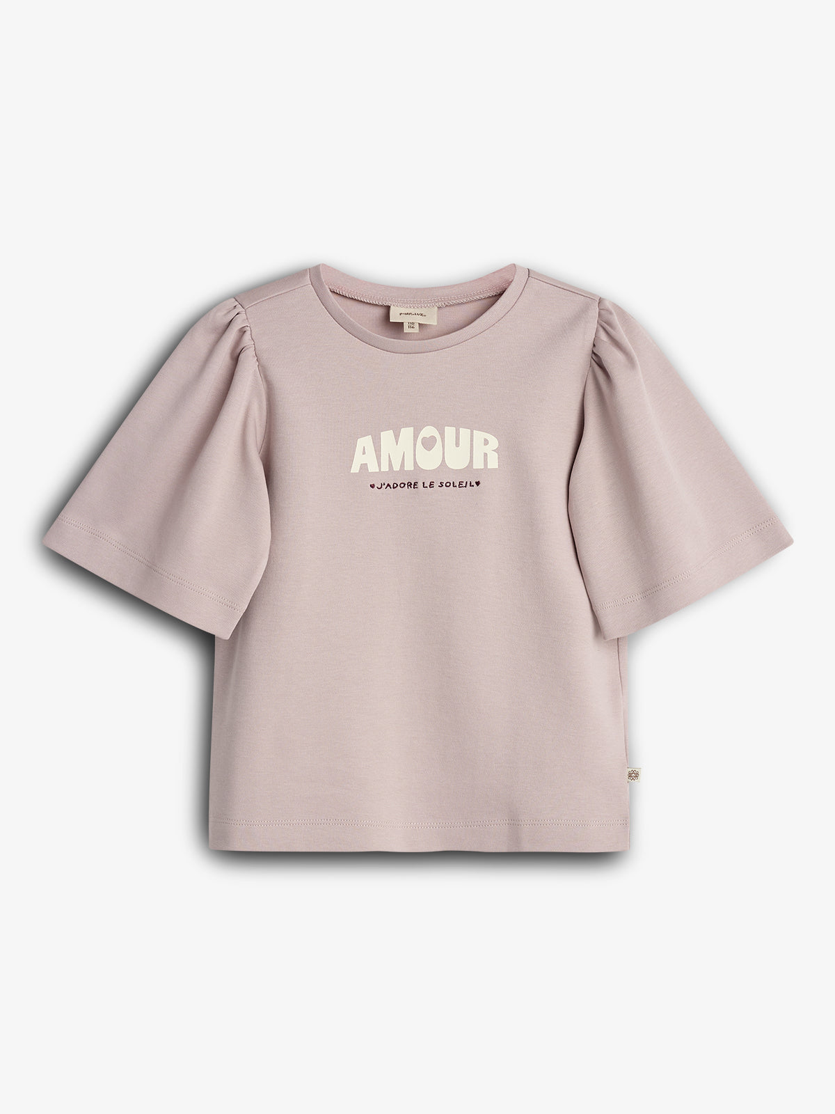A lavender T-shirt with puffed sleeves displays "AMOUR" and "J'ADORE LE SOLEIL" printed on the front. It hangs against a plain white background.