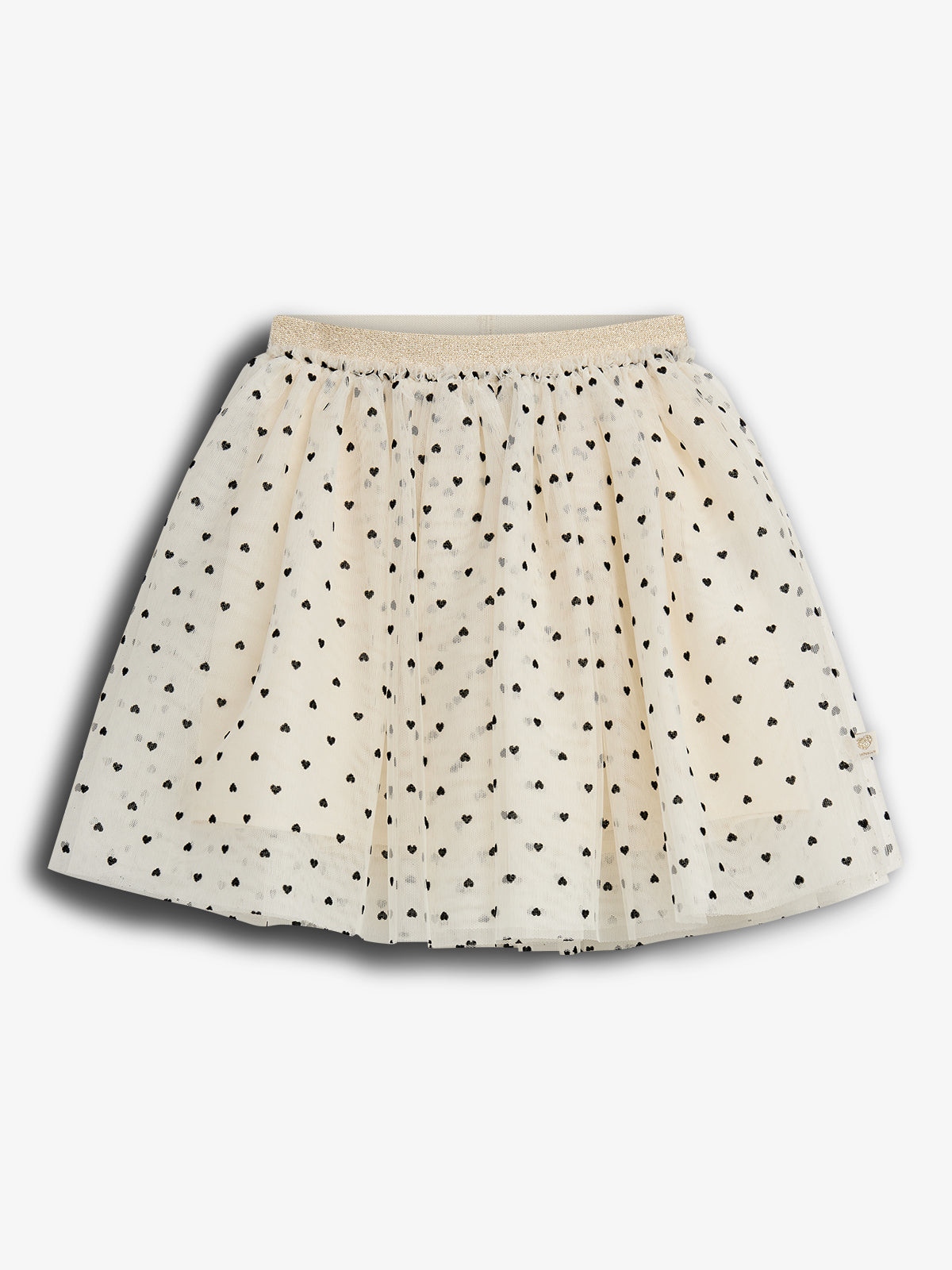 A cream-colored skirt features a pattern of small black hearts. It is pleated with a gold elastic waistband, displayed against a plain white background.