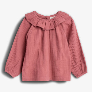 Pink, long-sleeved blouse with a ruffled collar is displayed against a plain white background. The fabric has a textured, crinkled appearance, and the sleeves are slightly gathered at the wrists.