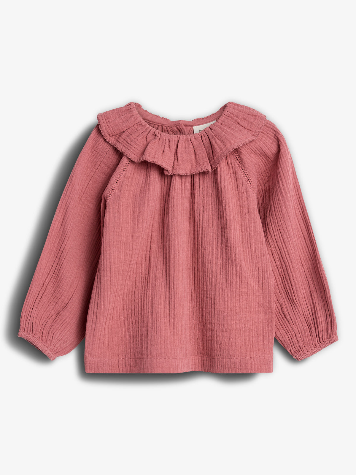 Pink, long-sleeved blouse with a ruffled collar is displayed against a plain white background. The fabric has a textured, crinkled appearance, and the sleeves are slightly gathered at the wrists.