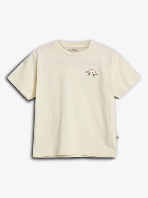 A cream-colored T-shirt features a small, simple drawing of an axolotl on the left chest, set against a plain white background.