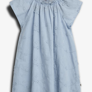 A light blue dress features floral embroidery, with short sleeves and a gathered neckline, displayed on a plain white background. A label inside the neckline reads "minä perhonen."