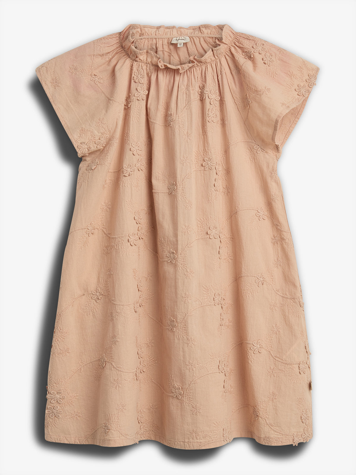 Peach-colored dress lies flat, featuring short sleeves and floral embroidery, set against a plain white backdrop.