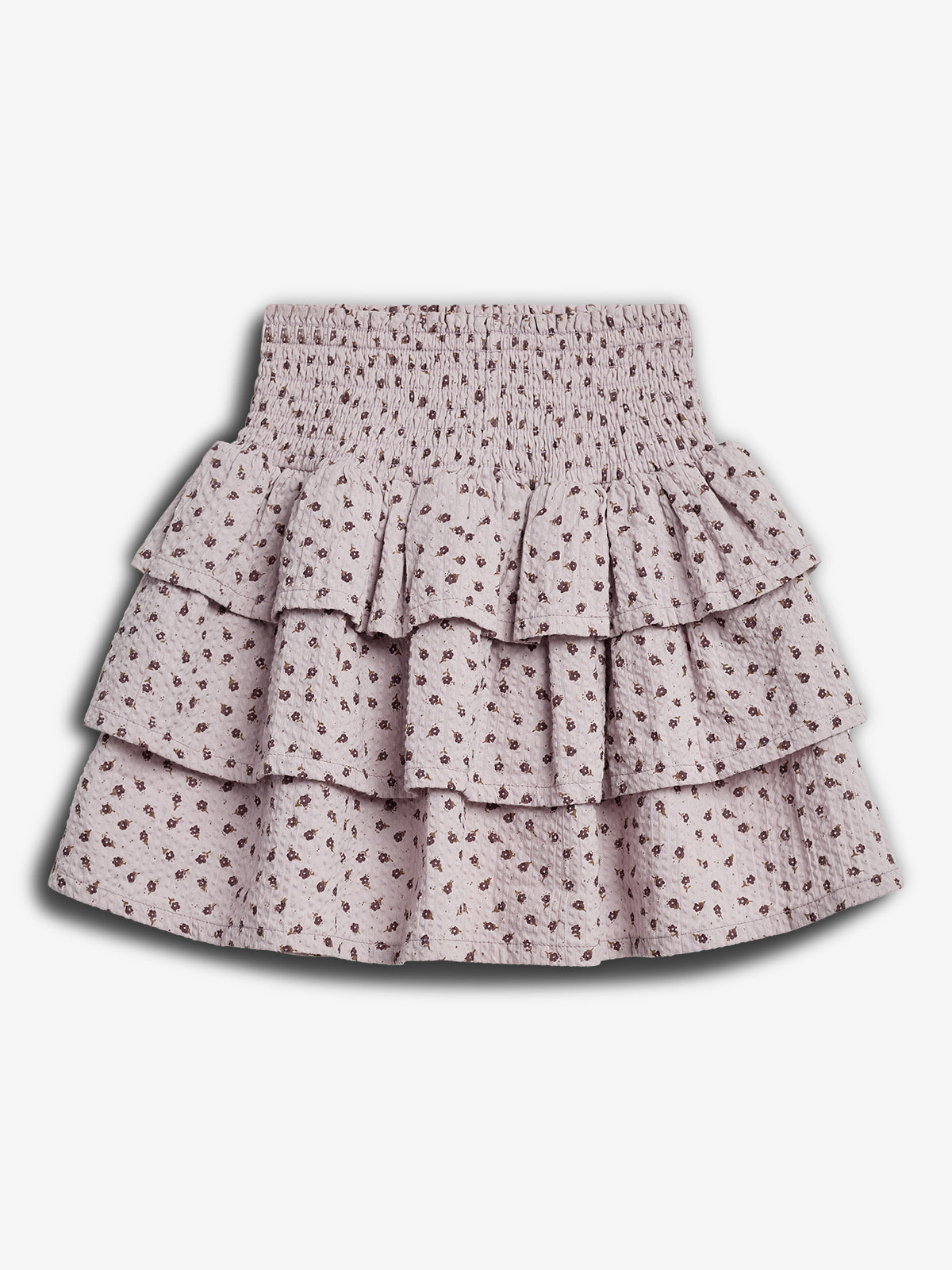 A tiered, floral-patterned skirt with a shirred, elastic waistband, displaying a soft-textured fabric. It rests against a plain white background, highlighting its light pink color and brown floral details.