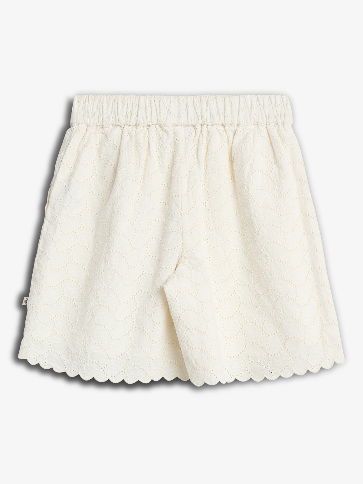 White lace shorts with an elastic waistband feature a scalloped hem and eyelet pattern, displayed against a plain white background.