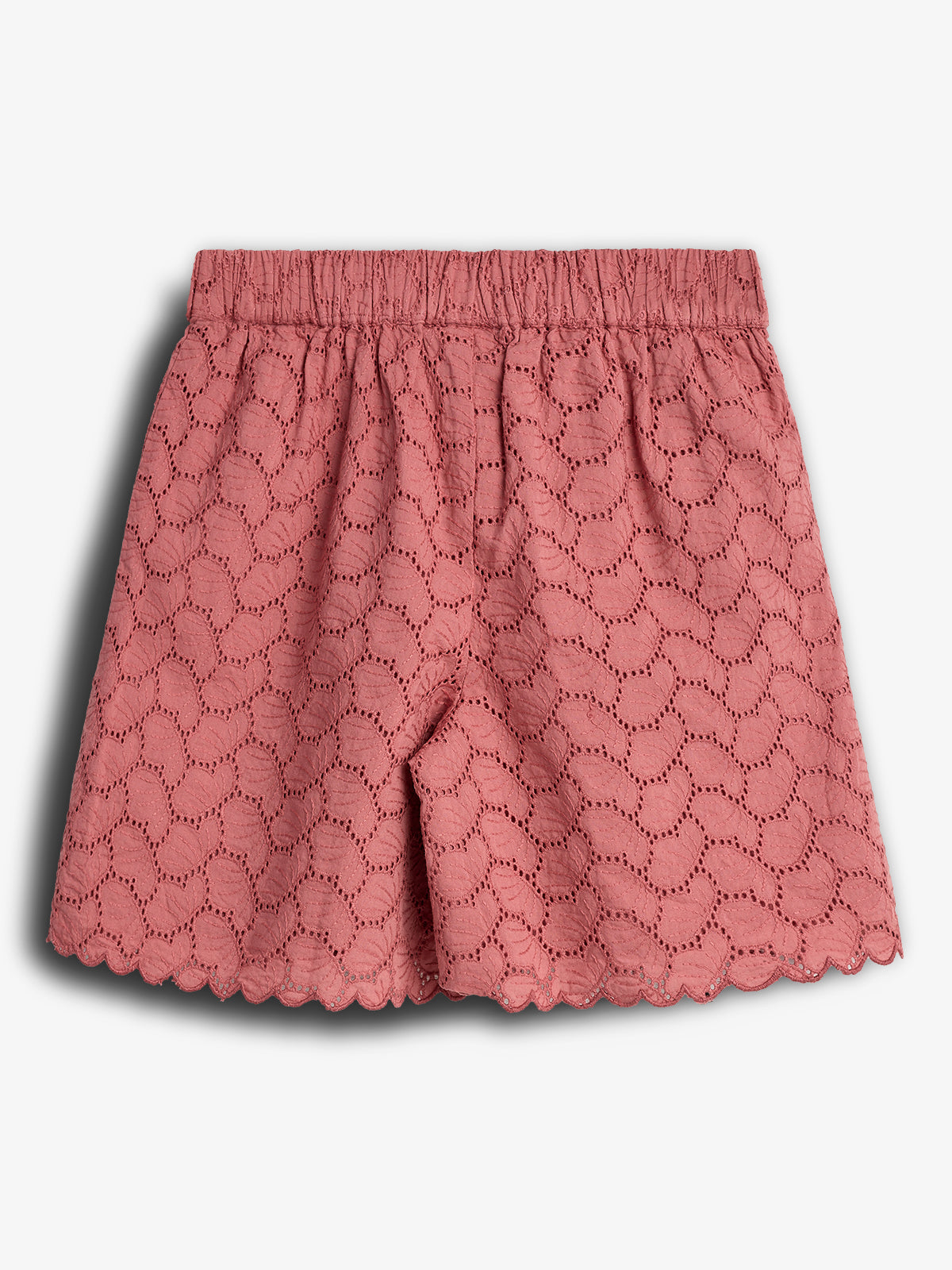Pink lace shorts feature an elastic waistband and scalloped hem. The eyelet pattern forms a wavy design, creating a delicate, feminine look against a plain white background. No text present.