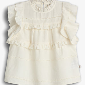 A cream-colored blouse with ruffled sleeves features delicate lace details across the front, set against a plain white background.