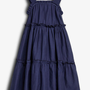 A sleeveless, navy blue, tiered dress with wide straps displayed against a plain white background, showcasing its ruffled, flowing layers.