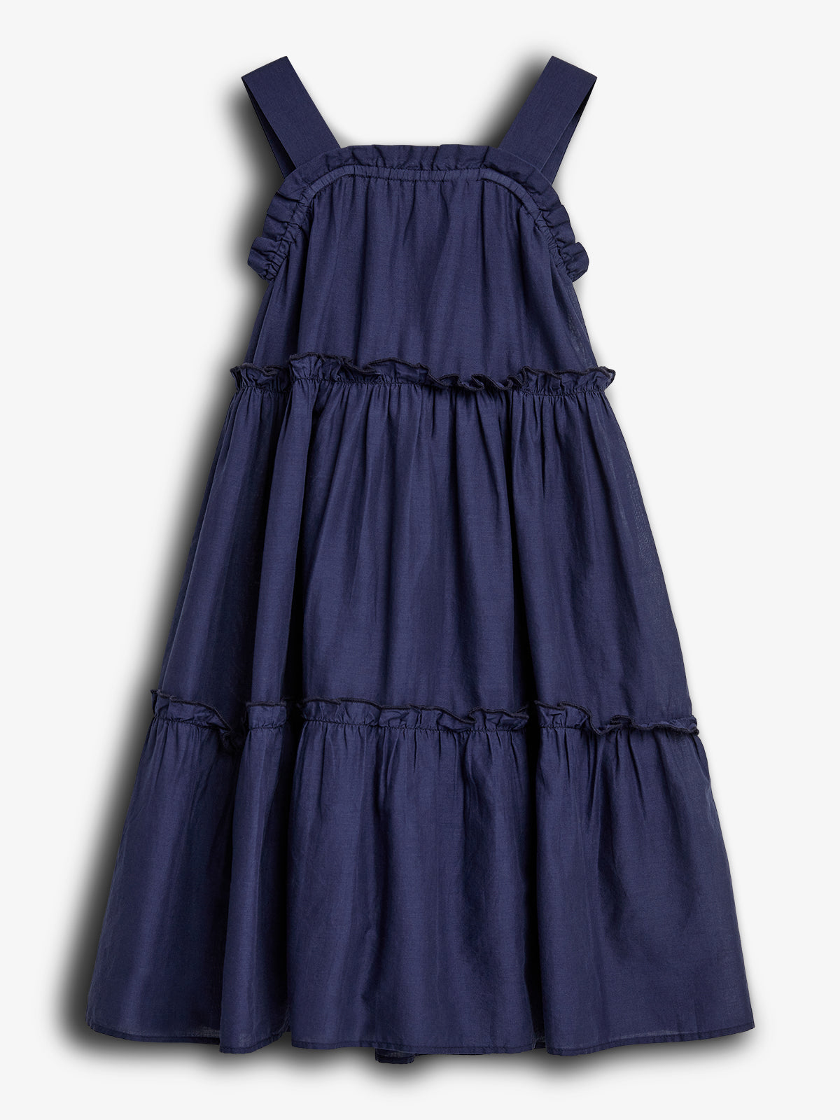 A sleeveless, navy blue, tiered dress with wide straps displayed against a plain white background, showcasing its ruffled, flowing layers.