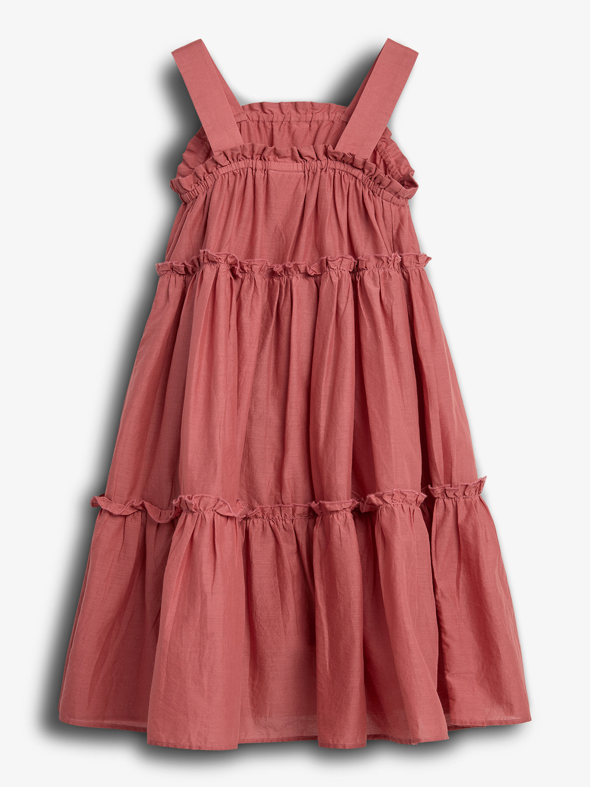 Pink tiered dress, featuring wide straps and ruffled accents, displayed on a plain white background. The dress hangs casually, showcasing its textured, gathered design for a relaxed appearance.