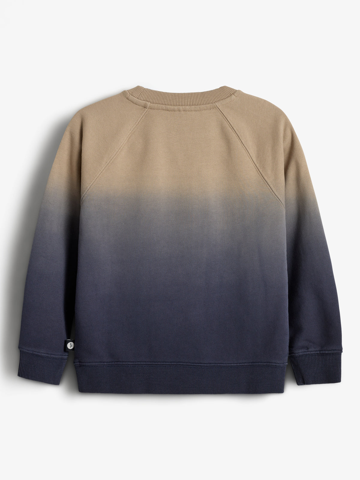A sweatshirt with a tan-to-navy gradient hangs against a plain light gray background, featuring ribbed cuffs and hem, creating a casual and stylish appearance. No text is present.