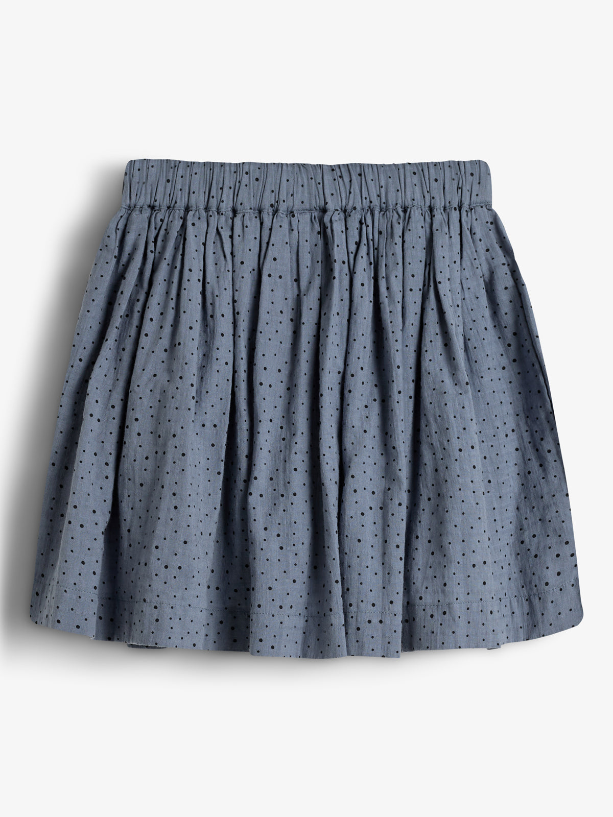 A blue, pleated skirt with black polka dots is displayed against a plain white background.