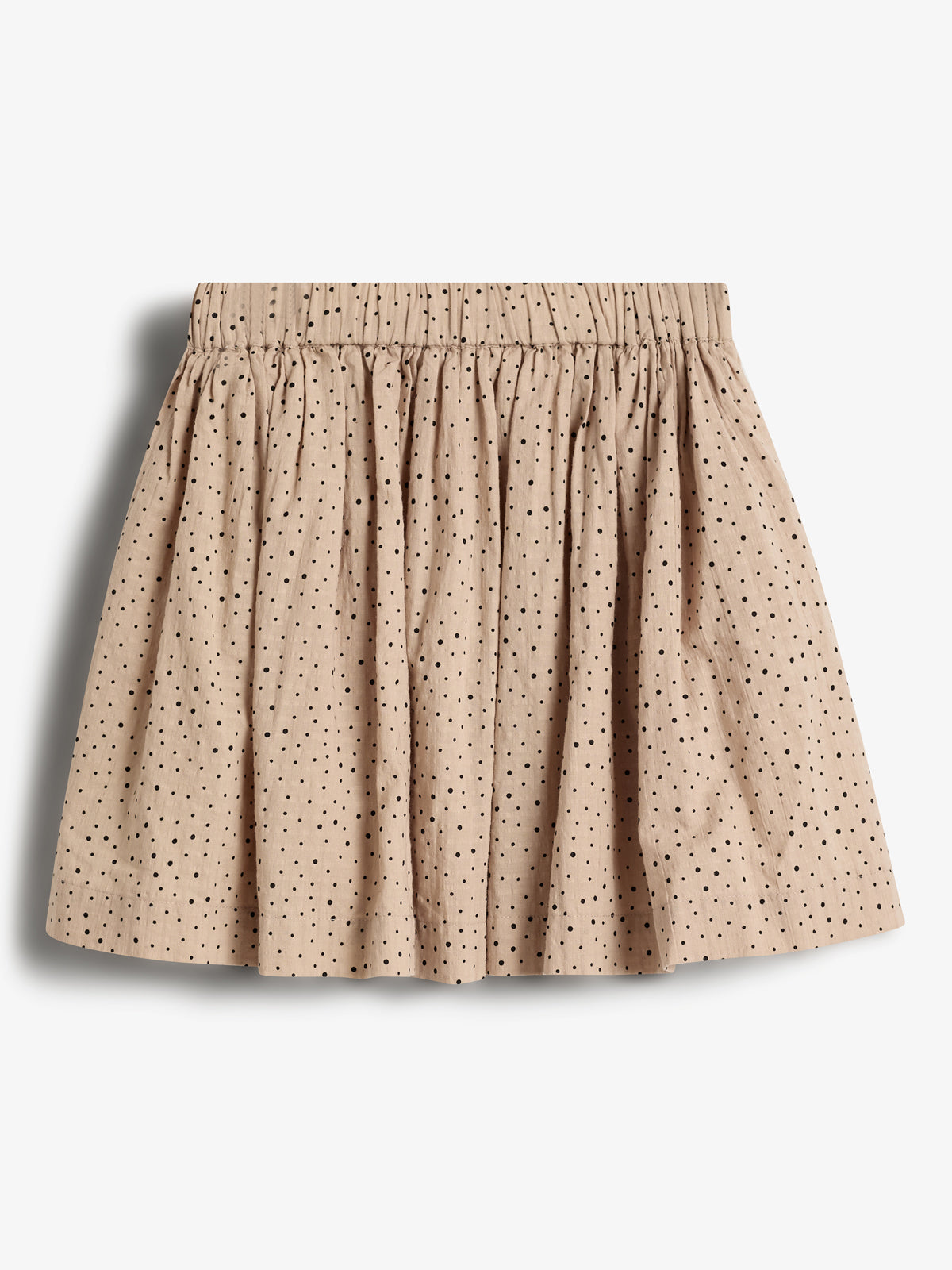 A beige skirt with black polka dots is displayed against a plain white background. The skirt features a gathered waistband and a pleated design, giving it a full appearance.