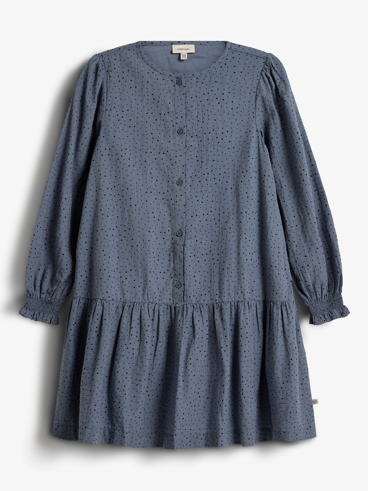 A blue, long-sleeve, button-up dress with a dotted pattern hangs against a white background. It features gathered cuffs and a ruffled hem. Text on the label reads "PRIMARK" and "10."