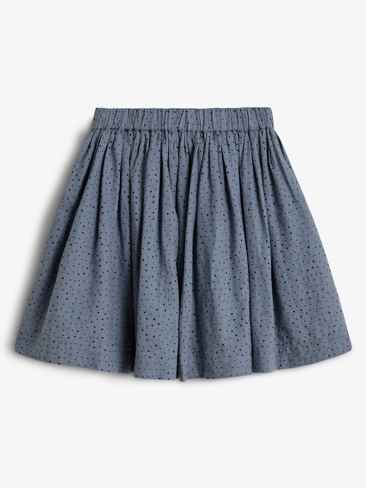 A blue pleated skirt with small black polka dots, featuring an elastic waistband. It's laid flat on a plain white background, showcasing its simple and elegant design.