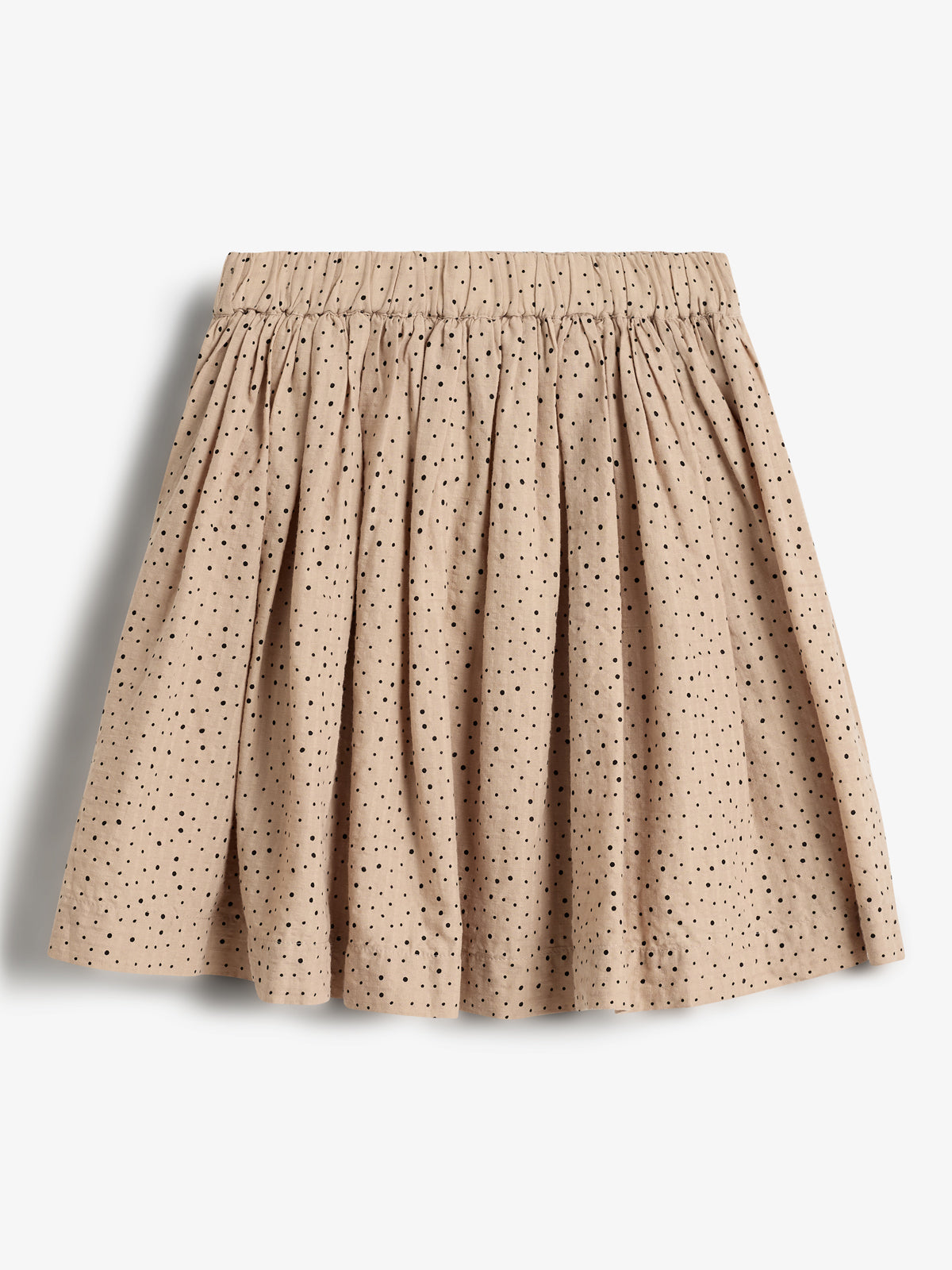 A beige skirt with black polka dots, featuring an elastic waistband and gathered fabric, displayed against a plain white background.
