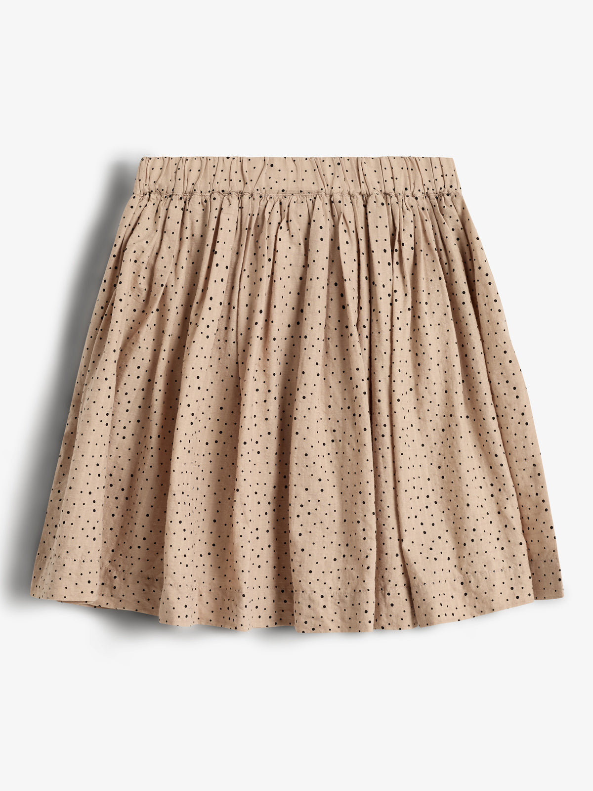 A beige, pleated skirt with black polka dots is displayed against a plain white background. The skirt has a gathered, elastic waistband, creating soft, flowing folds.